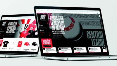 Deux ordinateurs portables affichant un site événementiel sur le baseball japonais avec design immersif noir, rouge et blanc.