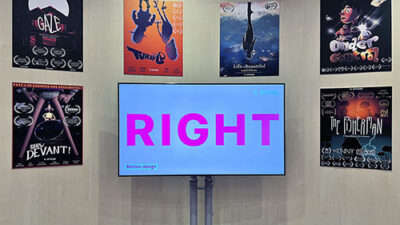 Écran d’exposition présentant des projets de motion design entouré d’affiches étudiantes récompensées