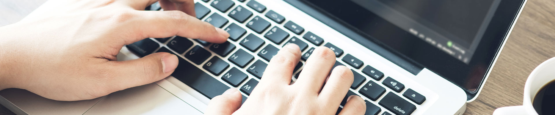Mains qui tapent sur un ordinateur portable